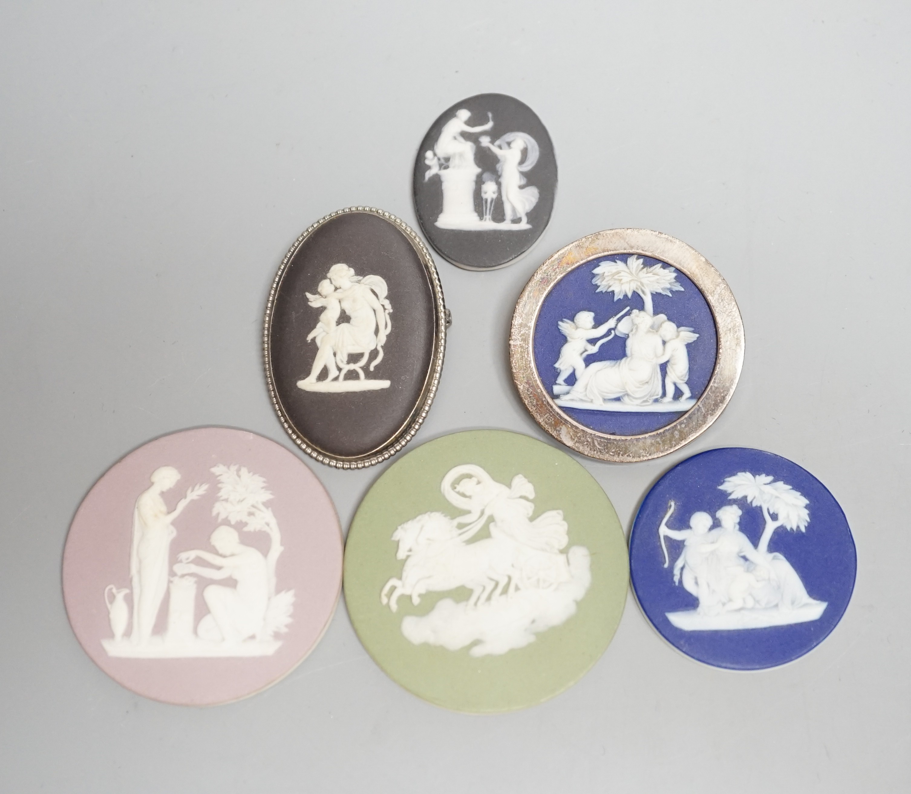 Two Wedgwood jasperware brooches, 20th century and four 19th century Wedgwood jasper plaques, largest 5.2 cm diameter